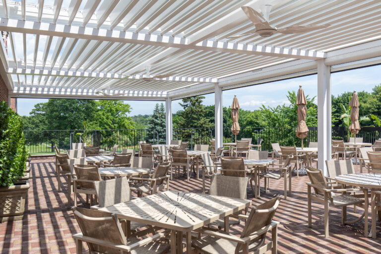 Commercial outdoor dining patio in Colorado featuring a large motorized louvered pergola with outdoor seating and year-round shade protection.
